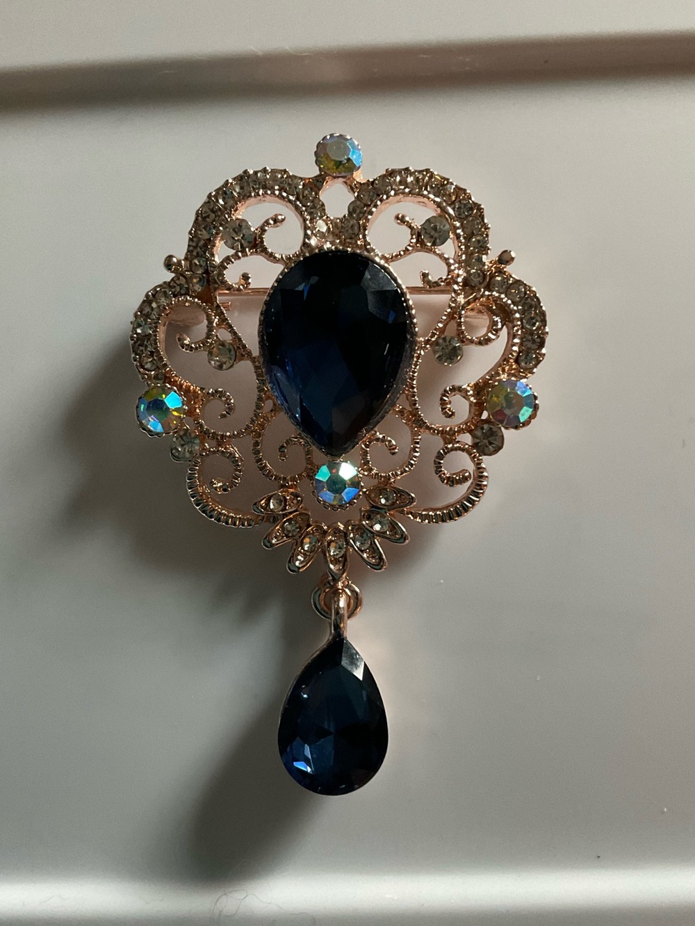 Blue Crystal Queen Vintage Looking Brooch w/ Blue Teardrop Scroll Design 2 1/4”